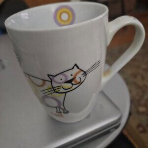 ceramic mug with a cartoon cat design